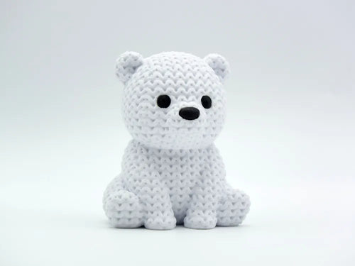 White knitted textured 3D printed baby polar bear figure/ key tag on a white background