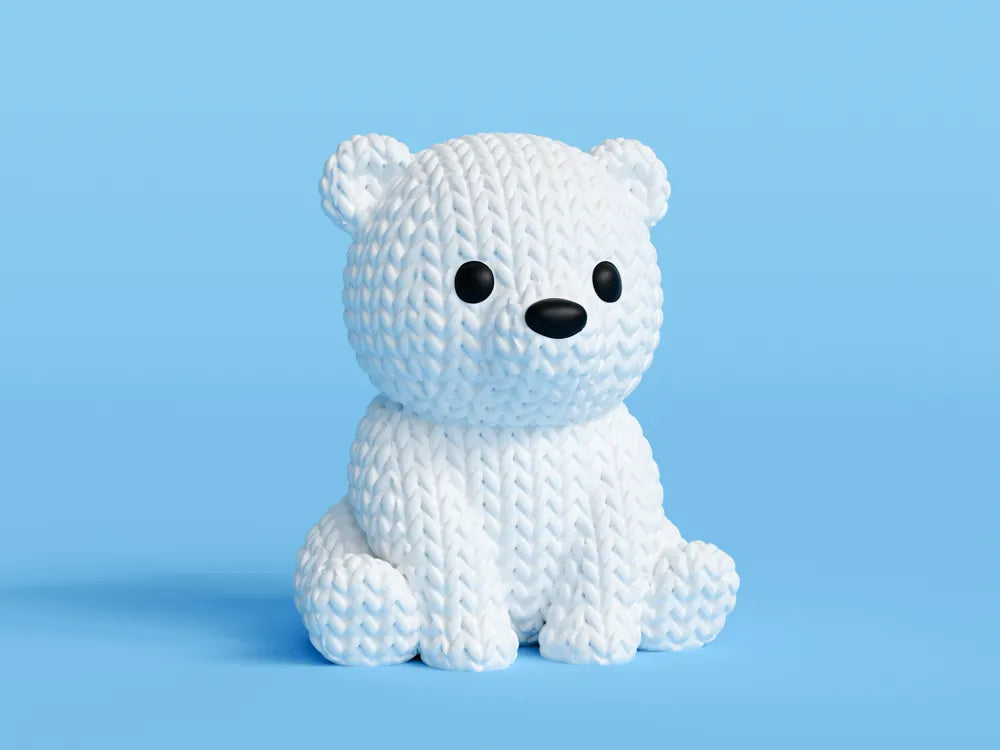 White knitted textured 3D printed baby polar bear figure/ key tag on a light blue background