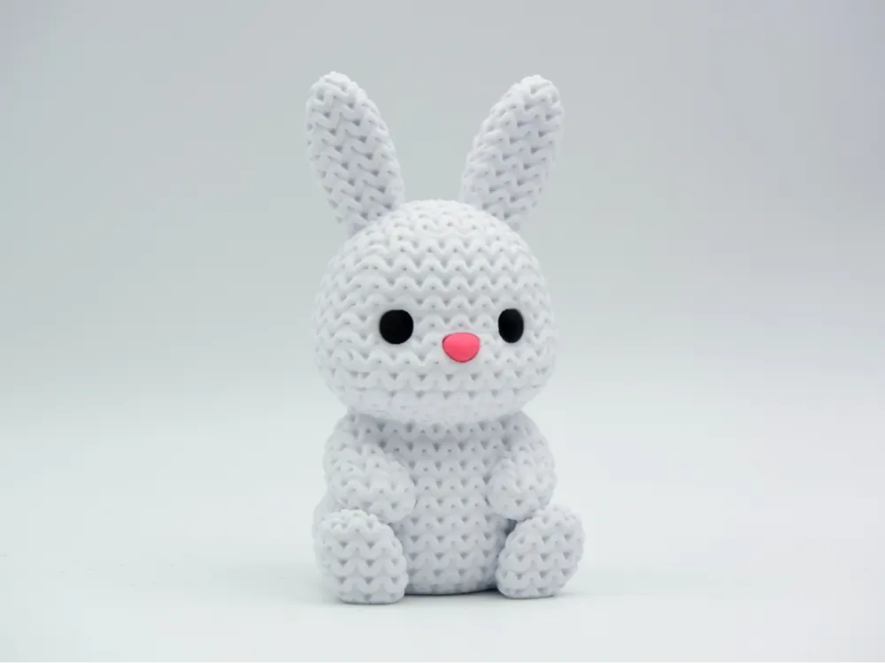 White coloured knitted textured 3D printed Bunny figure/ key tag on a white background