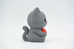 Grey coloured knitted textured 3D printed Cat with heart figure/ key tag on a white background facing side ways