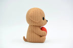 Caramel coloured knitted textured 3D printed Dog with heart figure/ key tag on a white background facing side ways