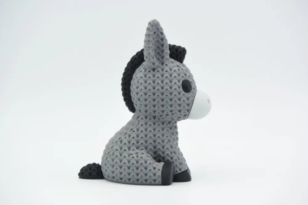 Grey coloured knitted textured 3D printed Donkey with heart figure/ key tag on a white background facing sideways