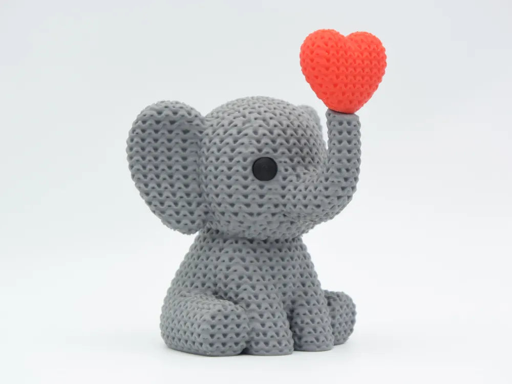 Grey coloured knitted textured 3D printed Elephant with heart figure/ key tag on a white background