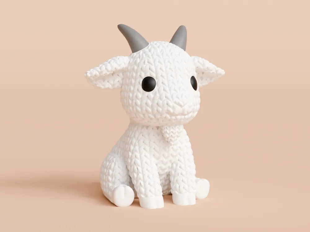White knitted textured 3D printed Goat figure/ key tag on a light orange background