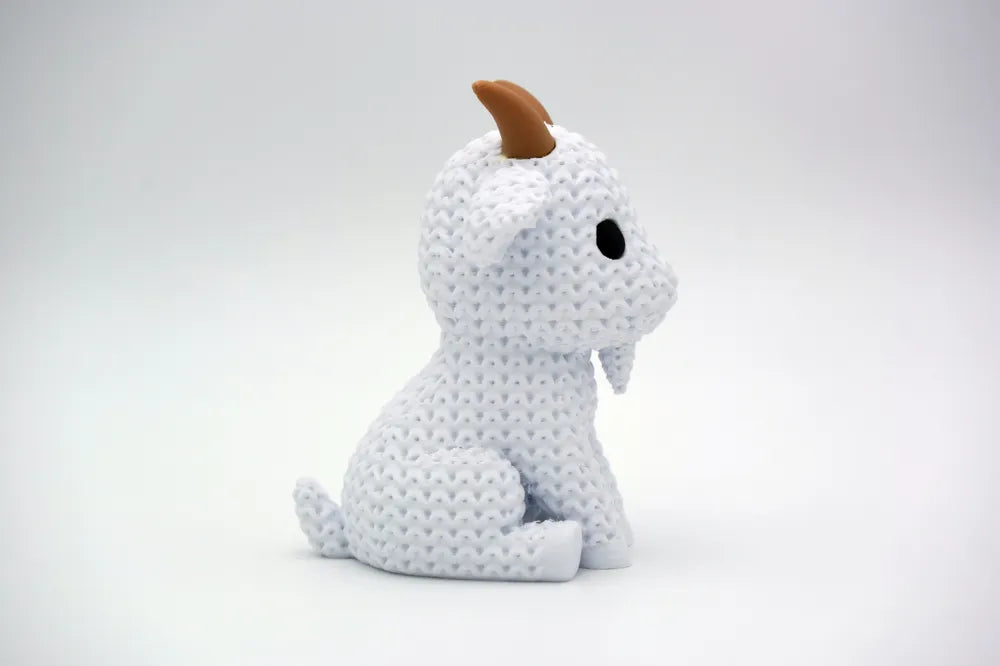 White knitted textured 3D printed Goat figure/ key tag on a white background facing side ways