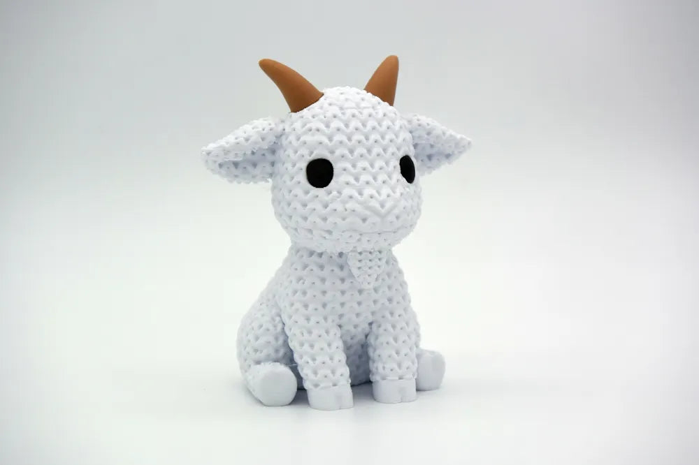 White knitted textured 3D printed Goat figure/ key tag on a white background