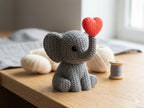 Knitted textured 3D printed elephant Figure/ key tag with a red heart on a wooden surface