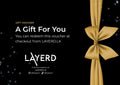 Gift voucher with a gold bow on a black background, featuring the Layerd brand.