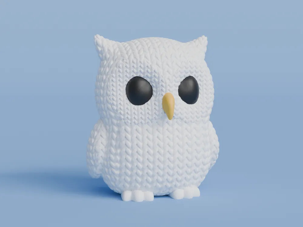 White knitted textured 3D printed Owl figure/ key tag on a light blue background