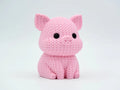 Pink knitted textured 3D printed pig figure/ key tag on a white background