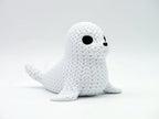 White knitted textured 3D printed seal figure/ key tag on a white background