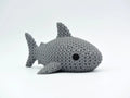 Grey knitted textured 3D printed shark figure/ key tag on a white background