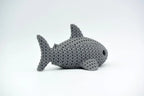 Grey knitted textured 3D printed Shark figure/ key tag on a white background facing side ways