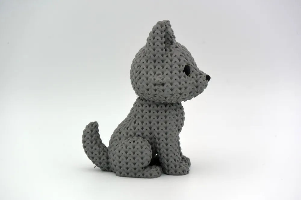 Grey knitted textured 3D printed Wolf figure/ key tag on a white background facing side ways